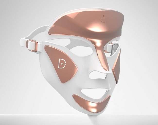 Na zdjęciu znajduje się maska LED w kolorze różowego złota w połączeniu z białym.